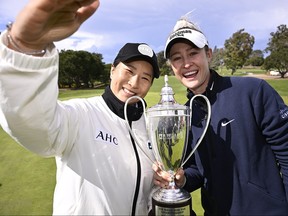 Nelly Korda of the United States and World Golf Hall of Famer Se Ri Pak imitate a selfie.