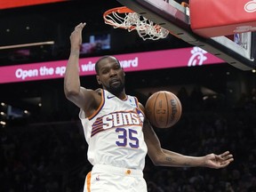Phoenix Suns forward Kevin Durant dunks against the Philadelphia 76ers during the second half of an NBA basketball game Wednesday, March 20, 2024, in Phoenix.
