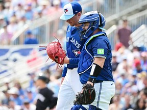 Alejandro Kirk (right) meets with Chris Bassitt of the Toronto Blue Jays in the mound in the third inning against the New York Yankees during a 2024 Grapefruit League Spring Training game at TD Ballpark on March 8, 2024 in Dunedin, Fla.