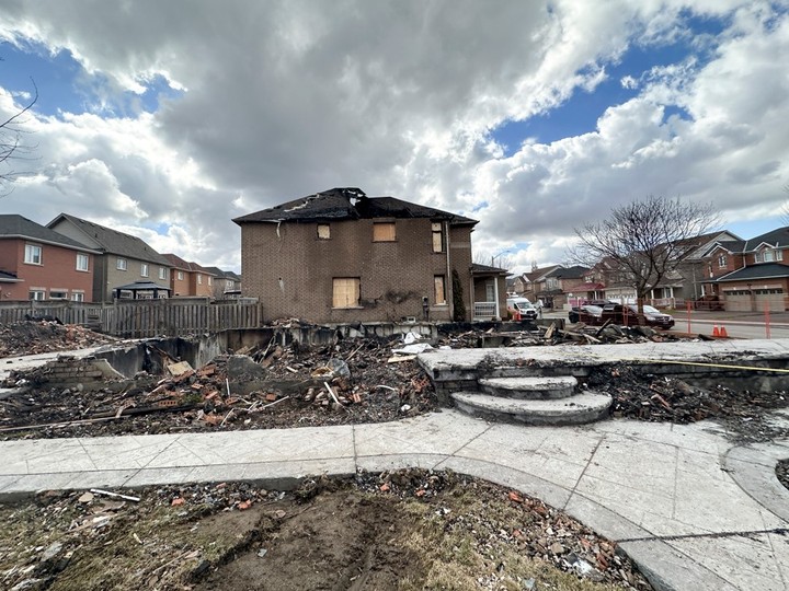  The charred remnants of a house at Van Kirk Dr. and Big Sky Rd., in Brampton, where a fire killed three members – Rajiv Warikoo, 51, his wife Shilpa Kotha, 47, and their daughter Mahek, 16 – is seen on Friday, March 15, 2024.