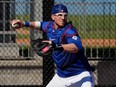 Toronto Blue Jays catcher Danny Jansen throws the ball in a drill during baseball spring training in Dunedin, Fla., Wednesday, Feb. 22, 2023.