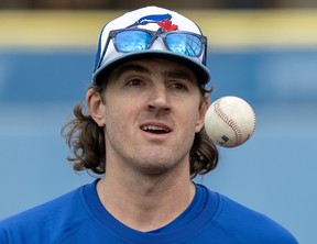 Blue Jays pitcher Kevin Gausman tosses a ball during spring training action in Dunedin, Fla., Thursday, Feb. 15, 2024.