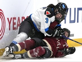 Toronto's Jocelyne Larocque slides into the boards with Montreal's Kristin O'Neill.