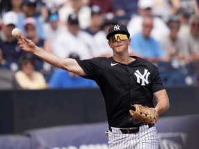 New York Yankees third baseman DJ LeMahieu throws out Boston Red Sox's Dalton Guthrie at first base in the third inning of a spring training baseball game Wednesday, March 13, 2024, in Tampa, Fla.