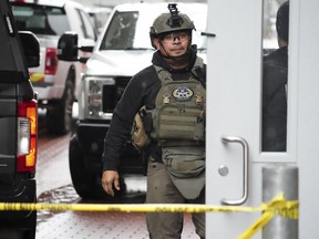 An officer with the Pennsylvania State Police Hazardous Device and Explosives Section walks into a building