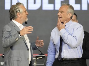 U.S. presidential candidate Robert F. Kennedy Jr., right, stands on the stage before a campaign event where he announced a running mate, Tuesday, March 26, 2024, in Oakland, Calif.