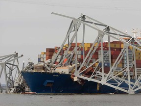Wreckage from the collapsed Francis Scott Key Bridge rests on the Dali cargo ship as efforts begin to clear the debris and reopen the Port of Baltimore on March 30, 2024, in Baltimore, Maryland.
