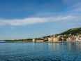 Ancient Kilitbahir Castle on the seashore under clear blue skies with scattered white clouds, Eceabat, Canakkale, Turkey