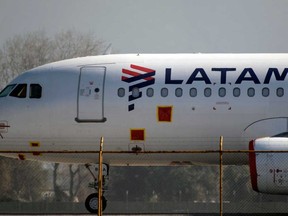 A LATAM Airlines plane sits on the tarmac at Santiago International Airport, in Santiago on May 26, 2020.