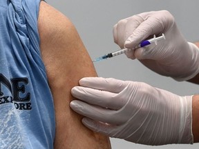 A man receives the Pfizer-BioNTech COVID-19 Vaccine at a vaccination center in Nuremberg, southern Germany, on March 18, 2021.