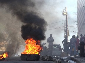 tires on fire near the main prison of Port-au-Prince