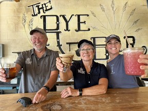 Tarpon Springs Distillery owners Barry and Lisa Butler raise a glass along with staffer Jessi Rogers at the distillery’s rye bar. IAN SHANTZ/TORONTO SUN