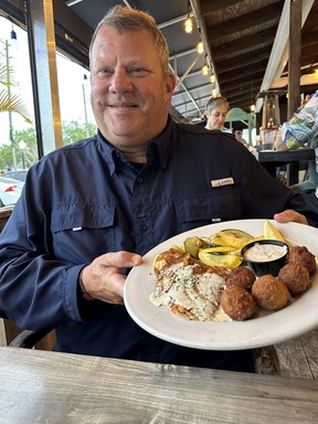 Walt Wickman shows off a fresh Hogfish dish at his Hog Island Fish Camp in Dunedin. IAN SHANTZ/TORONTO SUN