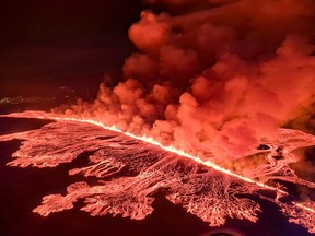 This handout photo released by the Icelandic Coast Guard on Saturday, March 16, 2024, shows billowing smoke and flowing lava pouring out of a new fissure, during a surveillance flight above a new volcanic eruption on the outskirts of the evacuated town of Grindavik, in western Iceland.