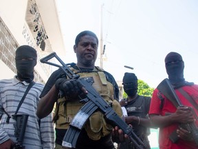 Armed gang leader Jimmy "Barbecue" Cherizier and his men are seen in Port-au-Prince, Haiti, March 5, 2024.