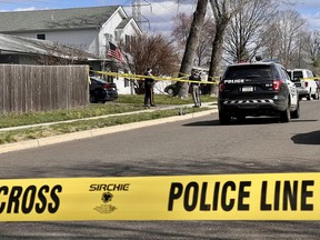 Police guard a home during an active shooter situation