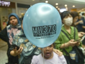 A person holds a balloon during an event held by relatives of the passengers and supporters to mark the 10th year since the disappearance of Malaysia Airlines flight MH370 in Subang Jaya on March 3, 2024.