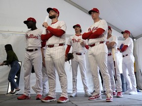 Philadelphia Phillies players wait to have their photo taken during a baseball spring training photo day Thursday, Feb. 22, 2024, in Clearwater, Fla.