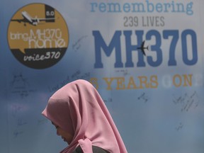 A girl stands in front of a condolence message board