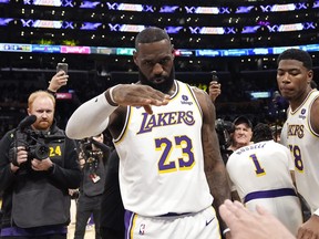 Los Angeles Lakers forward LeBron James salutes public address announcer Lawrence Tanter prior to an NBA basketball game against the Denver Nuggets Saturday, March 2, 2024, in Los Angeles.
