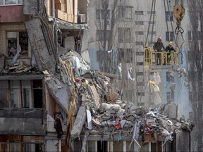 Rescuers clear debris from a multi-story building heavily damaged following a drone strike, in Odesa on March 3, 2024, amid the Russian invasion of Ukraine.