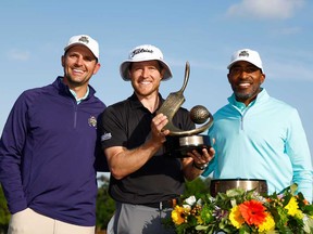 Peter Malnati of the United States and Ronde Barber pose with the Valspar Championship Trophy after the final round of the Valspar Championship at Copperhead Course at Innisbrook Resort and Golf Club on March 24, 2024 in Palm Harbor, Fla.