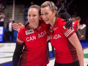 Team Canada skip Rachel Homan, left, and second Emma Miskew defeat team South Korea 9-7 to advance to Sunday final against team Switzerland at the BKT Tires World Woman's Curling Championship in Sydney, N.S., March 23, 2024.