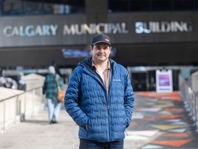 Calgarian and mayoral recall petition organizer Landon Johnston stands in front of city hall on Saturday, February 10, 2024.