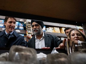 Prime Minister Justin Trudeau, left to right, Minister of Emergency Preparedness and Minister responsible for the Pacific Economic Development Agency of Canada Harjit S. Sajjan and Deputy Prime Minister and Minister of Finance Chrystia Freeland look at tableware during a visit to the Punjab Food Center in Vancouver, Wednesday, March 27, 2024.