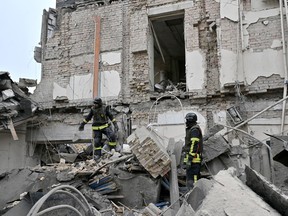 Ukrainian rescuers work at the site of a missile attack in Kyiv