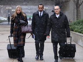 Umar Zameer (middle), who has pleaded not guilty to first-degree murder in the death of Toronto Police Const. Jeffrey Northrup on July 1, 2021 in the parking lot of Toronto's City Hall, is seen leaving the 361 University courthouse with his defence counsel Alexandra Heine and Nader Hasanon on Tuesday, March 19, 2024.