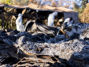An asbestos removal crew sifts through the ash and charred remains of the Goetze home and granite business, which was destroyed in the River Wildfire in August 2021 in Grass Valley, Calif. MUST CREDIT: Melina Mara/The Washington Post.