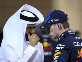 Red Bull driver Max Verstappen of the Netherlands, center, who qualified for pole position, speaks with FIA President Mohammed Ben Sulayem after qualification ahead of the Formula One Bahrain Grand Prix at the Bahrain International Circuit in Sakhir, Bahrain, Friday, March 1, 2024.