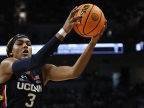 UConn forward Aaliyah Edwards pulls in a rebound during the second half of an NCAA college basketball game against South Carolina in Columbia, S.C., Sunday, Feb. 11, 2024.