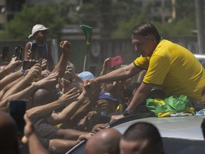 Former Brazil's President Jair Bolsonaro greets supporters after the launch of a campaign event launching the pre-candidacy of a mayoral candidate, in Rio de Janeiro, Brazil, Saturday, March 16, 2024.