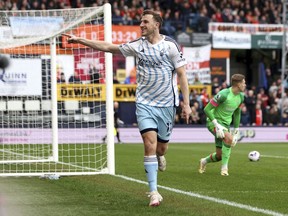 Nottingham Forest's Chris Wood celebrates scoring his side's first goal of the game, during the English Premier League soccer match between Luton Town and Nottingham Forest, at Kenilworth Road, in Luton, England, Saturday March 16, 2024.
