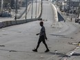 Canada is moving to reduce the number of diplomats at its embassy in Haiti, citing an increasingly volatile security situation in the Caribbean country. A pedestrian crosses a street free of traffic in Port-au-Prince, Haiti, Wednesday, March 13, 2024.