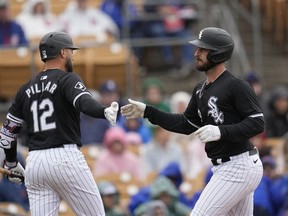 Chicago White Sox's Paul DeJong, right, celebrates after his two-run home run against the Chicago Cubs with teammate evin Pillar (12) during the second inning of a spring training baseball game Friday, March 15, 2024, in Phoenix.