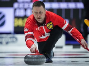 Team Canada skip Brad Gushue delivers a rock while playing Team Alberta-Bottcher during the playoffs at the Brier, in Regina, Saturday, March 9, 2024.