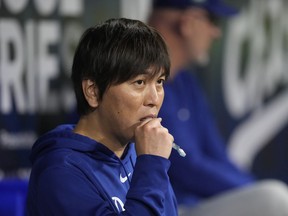 Los Angeles Dodgers designated hitter Shohei Ohtani's former interpreter Ippei Mizuhara stands in the dugout.