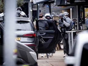 A man is arrested by members of the DSI special police forces after several people were taken hostages in a cafe in Ede, on March 30, 2024.