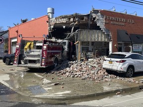 A firetruck sits amid rubble after crashing into a furniture store, Friday, March 1, 2024, in Rockville, Center.