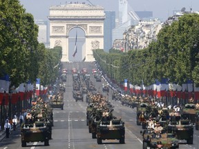 FILE - French VAB armored personnel carriers, front rows from left, attend the Bastille Day parade in Paris, July 14, 2013. French Defense Minister Sébastien Lecornu said France is going to deliver "hundreds" of armored vehicles by the beginning of next year to Ukraine.