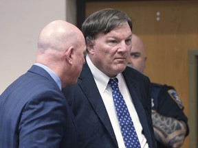 FILE - Alleged Gilgo serial killer Rex Heuermann appears inside Judge Timothy P. Mazzei's courtroom with his attorney Michael Brown at Suffolk County Court in Riverhead, N.Y. on Jan. 16, 2024. The estranged wife of Heuermann says she believes he is not capable of the crimes he is accused of, and she visits him in jail weekly despite pending divorce proceedings. Asa Ellerup told Newsday in a statement issued through her lawyer Wednesday, March 13, 2024 that she will listen to all of the evidence and withhold judgment.