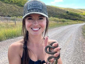 Influencer Hannah Barron holds a small snake.
