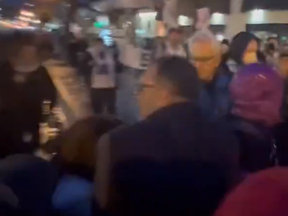 In a screengrab from video, a couple trying to enter a restaurant in Yorkville for an event attended by Deputy Prime Minister Chrystia Freeland and cabinet minister Ya’ara Saks are harassed by pro-Hamas protesters on Tuesday, March 5, 2024 in Toronto.