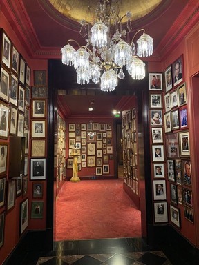 A hallway with just some of the portraits of Hotel Sacher's famed guests in Vienna.
