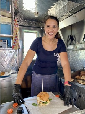 Chef Tham with her famous lionfish burger at Cactus Blue Food Truck at dive site No. 37 Corporal Meiss in Bonaire.