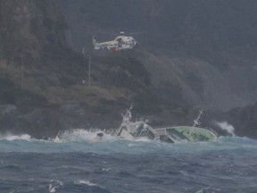 a helicopter hovers over a fishing boat