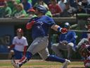 Toronto Blue Jays’ Alejandro Kirk hits an RBI-double off Philadelphia Phillies reliever Seranthony Domínguez during the sixth inning of a spring training baseball game at BayCare Ballpark, Sunday, March 17, 2024, in Clearwater, Fla.